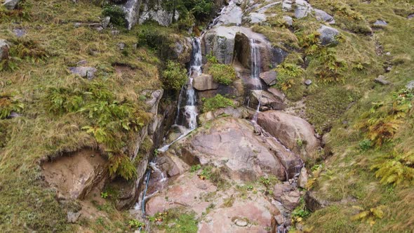 Waterfall in Rocky High Mountains in Cloud Weather