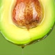 Half raw fresh organic green avocado fruit with oil stream - VideoHive Item for Sale