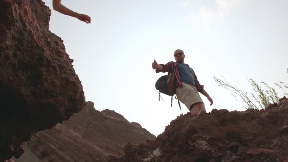 Couple Overcoming Challenge on Hiking Trip