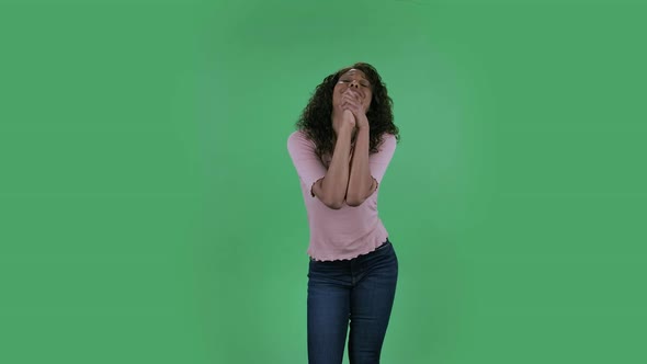 Portrait of Beautiful African American Young Woman Is Looking at Camera Is Keeping Palm Together and