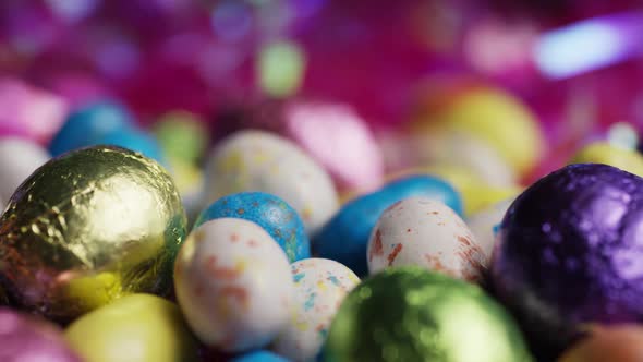 Rotating shot of colorful Easter candies on a bed of easter grass 