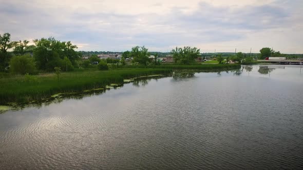 Aerial view of a large river in a swampy countryside.