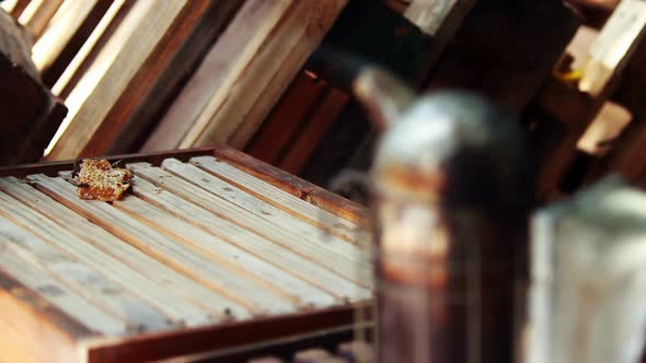 Close-up of beehive box and smoker