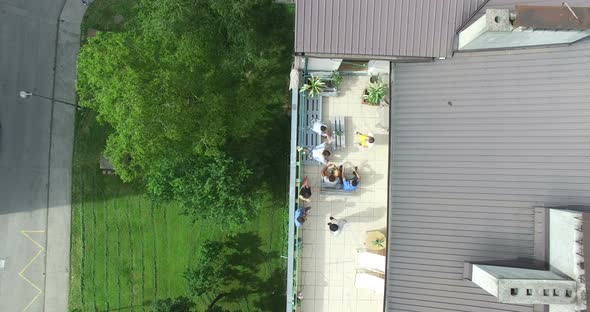 Top view of group of friends hanging out at rooftop party