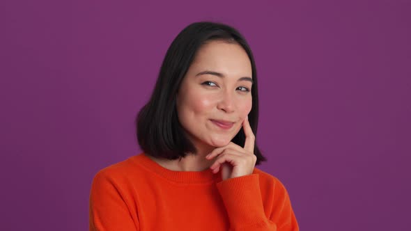 Pensive happy woman in red sweater thinking