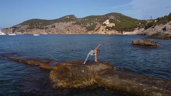 Woman doing yoga at seaside