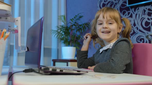 Girl Doing Online Homework with Teacher Using Digital Laptop Computer at Home Distance Education