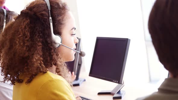 Portrait of smiling customer service executive working at desk