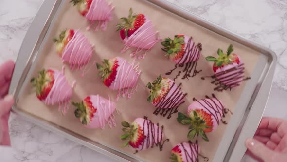 Flat lay. Step by step. Variety of chocolate dipped strawberries on a parchment paper.