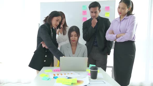 Business People Proficiently Discuss Work Project on Computer