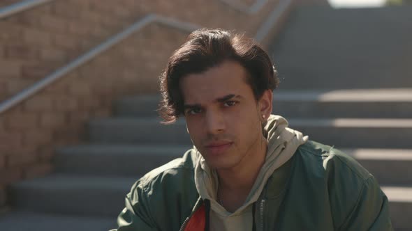 Stylish Male Hipster Resting on Outdoors Stairs