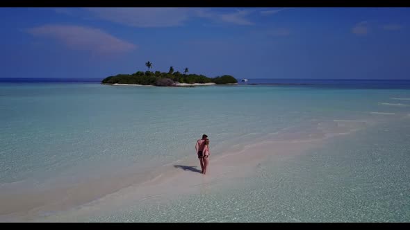 Man and woman posing on paradise sea view beach voyage by transparent sea and white sandy background