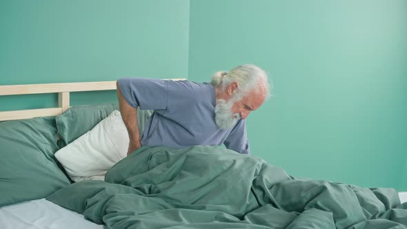 Elderly Man Suffers From Back Pain Discomfort in the Lower Back Pinched Nerve
