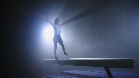 Artistic Gymnastics on Balance Beam Young Sportswoman is Training in Dark Hall Professional Sport