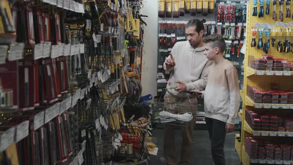 Man and Kid Shopping at Hardware Store