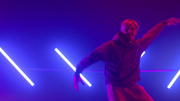 Guy Dancing Street Style in Neon Backlit