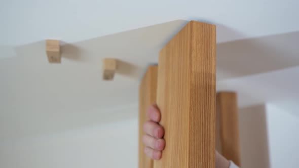 the Carpenter Secures Wooden Ash Lamellae to the Ceiling