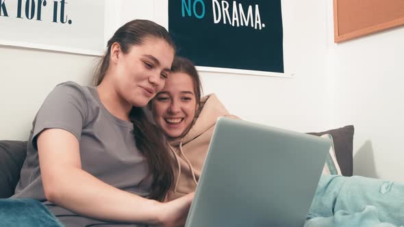 Young Women Looking at Laptop and Laughing