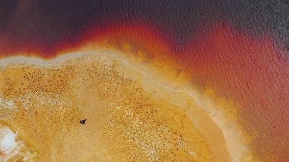 Mars planet Man is standing on shore of the red lake Ural Mars