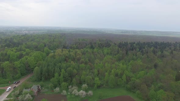 Aerial View of Small Country City and Surrounding Forest Landscape