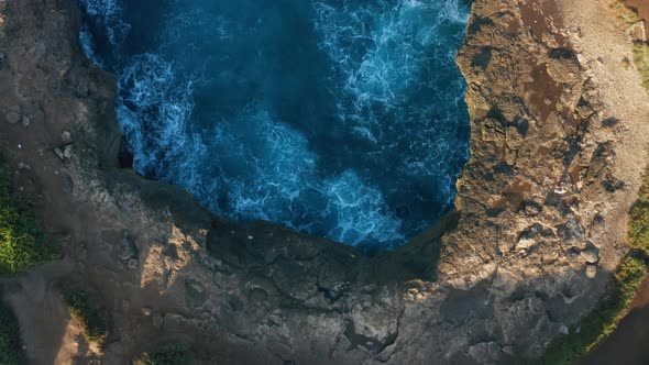 Aerial footage in Nusa Penida. Awesome power of waves breaking over dangerous rocks.