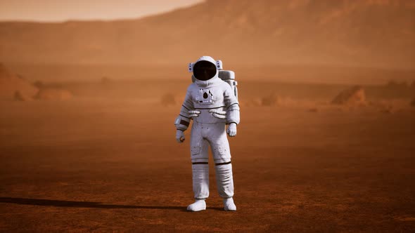 Astronaut on Mars Surface. Red Planet Covered in Gas and Rock