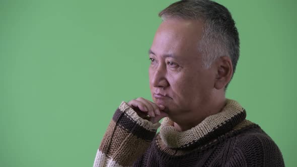 Profile View of Happy Mature Japanese Man Thinking Ready for Winter