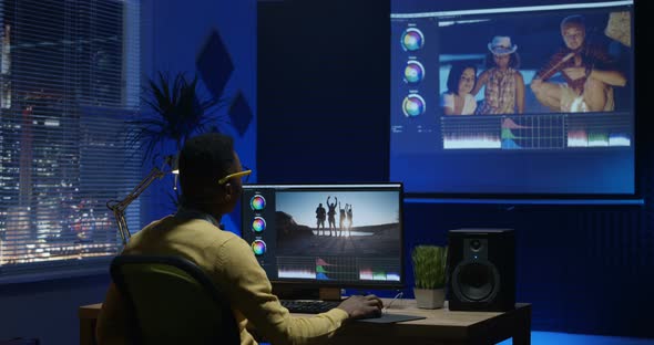 Young Man Editing Video Inside a Room