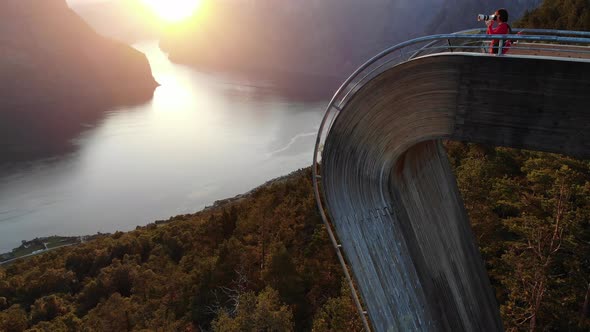 Tourist Enjoying Fjord View On Stegastein Viewpoint Norway