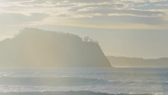 Ocean waves crashing on the beach Playa Buena Vista, Costa Rica, on a sunny evening