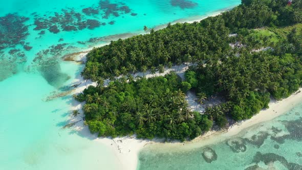 Wide angle fly over copy space shot of a sandy white paradise beach and blue ocean background in col