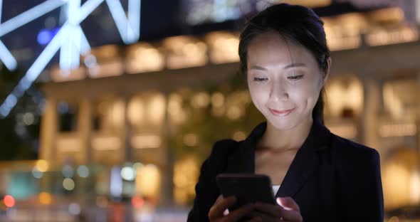 Young woman use of mobile phone in city