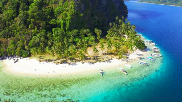 Tourist Boats and Swiming People on the Amazing Nature Pinagbuyutan Island and Azure Sea of El Nido