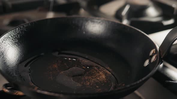 Pour Oil on Frying Pan on Electric Stove. Pour Oil on Frying Pan on Cafe Stove