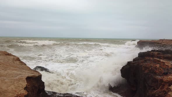 Slow Motion of Extreme Sea Wave Against the Rock in the Ocean