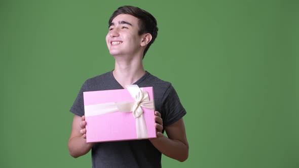 Young Handsome Iranian Teenage Boy Against Green Background