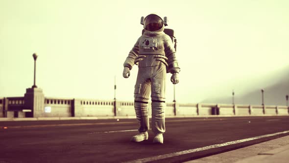 Astronaut in Space Suit on the Road Bridge alt