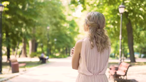 Agitated Curly-Haired Beauty Looking Forward to Her Boyfriend, Tender Feelings