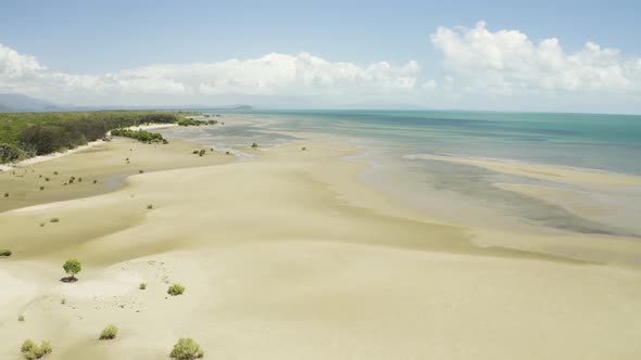 Aerial, Low Tide And Huge Sand Ocean Bed And Mangroves Growing In Queensland Australia