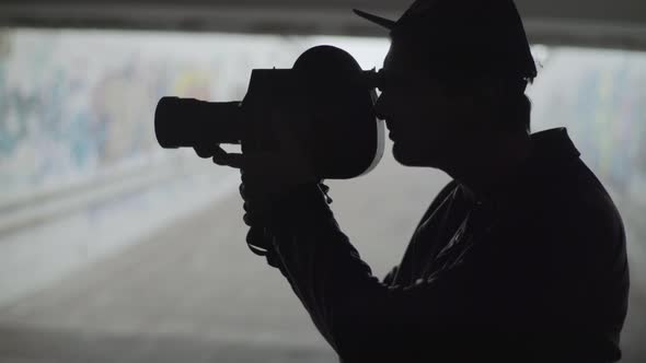 A Male Cameraman Shoots Video on an Old Vintage Camera Krasnogorsk. Kyiv. Ukraine