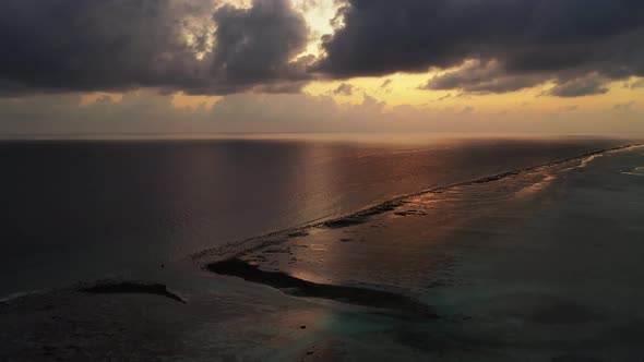 Wide angle flying tourism shot of a sunshine white sandy paradise beach and blue sea background