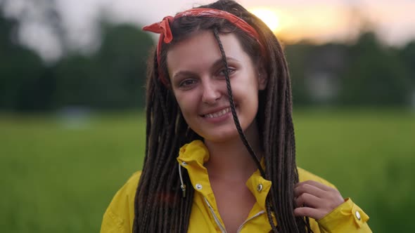 Close Up Portrait of Young Woman Smiling in Wind Looking at Sunset Over Forest