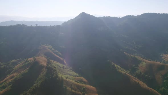 Aerial top view of forest trees and green mountain hills. Nature landscape background, Thailand.