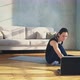 Young Woman Presses Key on Laptop and Lies Down on Mat - VideoHive Item for Sale