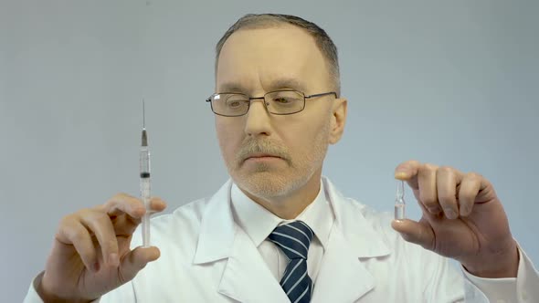 Doctor Holding Syringe and Ampoule, Prescribing Effective Medication to Patient