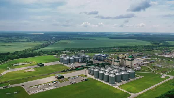 Large granary in field. Agricultural grain elevator building for storage