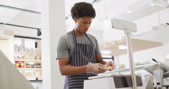 Animation of focused biracial waiter weighting cheese