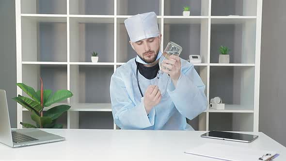 Doctor's View of the Jar with the Drug. The Doctor Dials the Medicine From a Large Glass Jar Into a alt