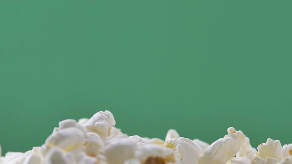 Fresh Popcorn Falls on Top of a Pile Isolated on ChromaKey Background