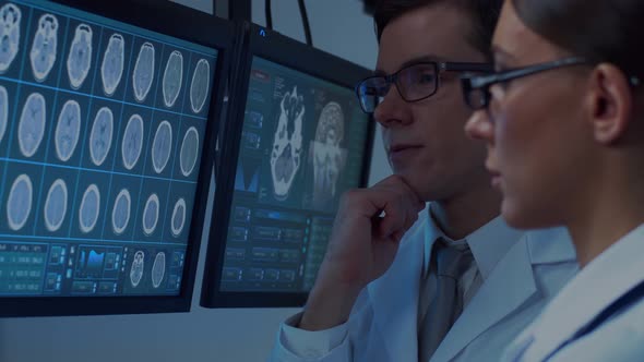 Professional medical doctors working in hospital office making computer research.